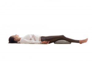 Woman lying in relaxation or Savasana
