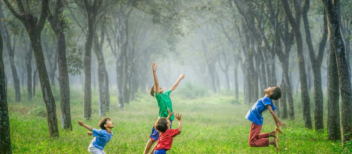 Children jumping in a natural surrounding