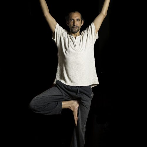 Man standing in Tree Pose
